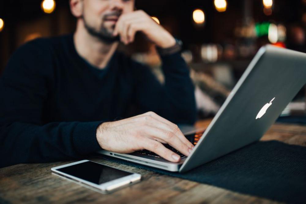 Young Entrepreneur Working from a Modern Cafe Young Entrepreneur Working from a Modern Cafe