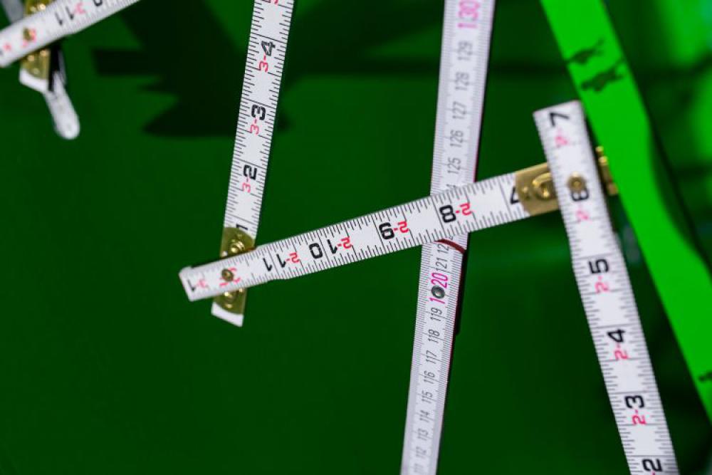 Extandable wooden ruler on a green background Extandable wooden ruler on a green background