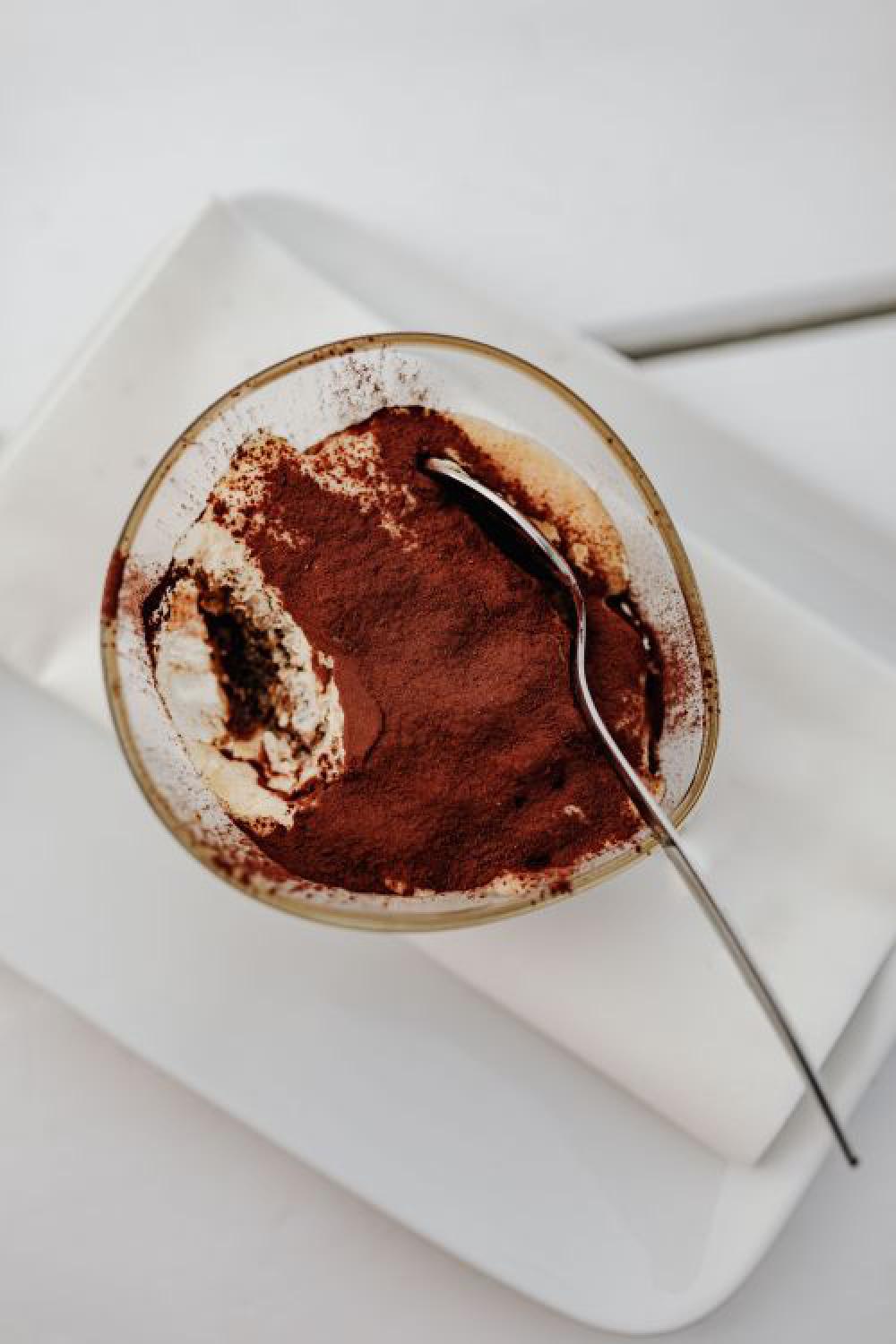 Working with a laptop by the sea. Cup of coffee and delicious tiramisu, Marina di Puolo, Italy Working with a laptop by the sea. Cup of coffee and delicious tiramisu, Marina di Puolo, Italy