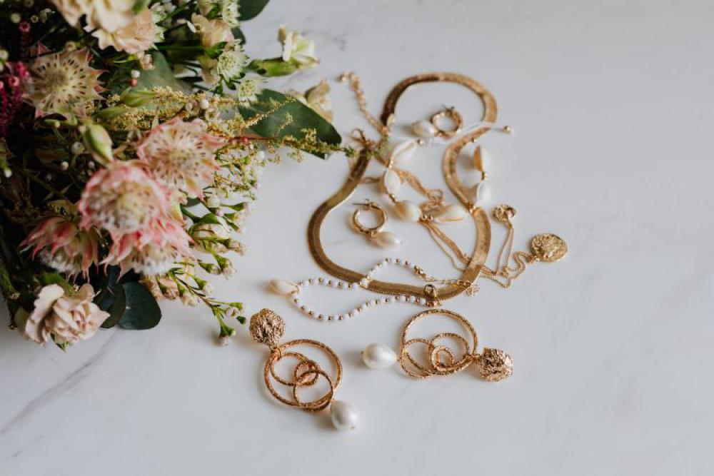 Gold jewelry on white marble Gold jewelry on white marble