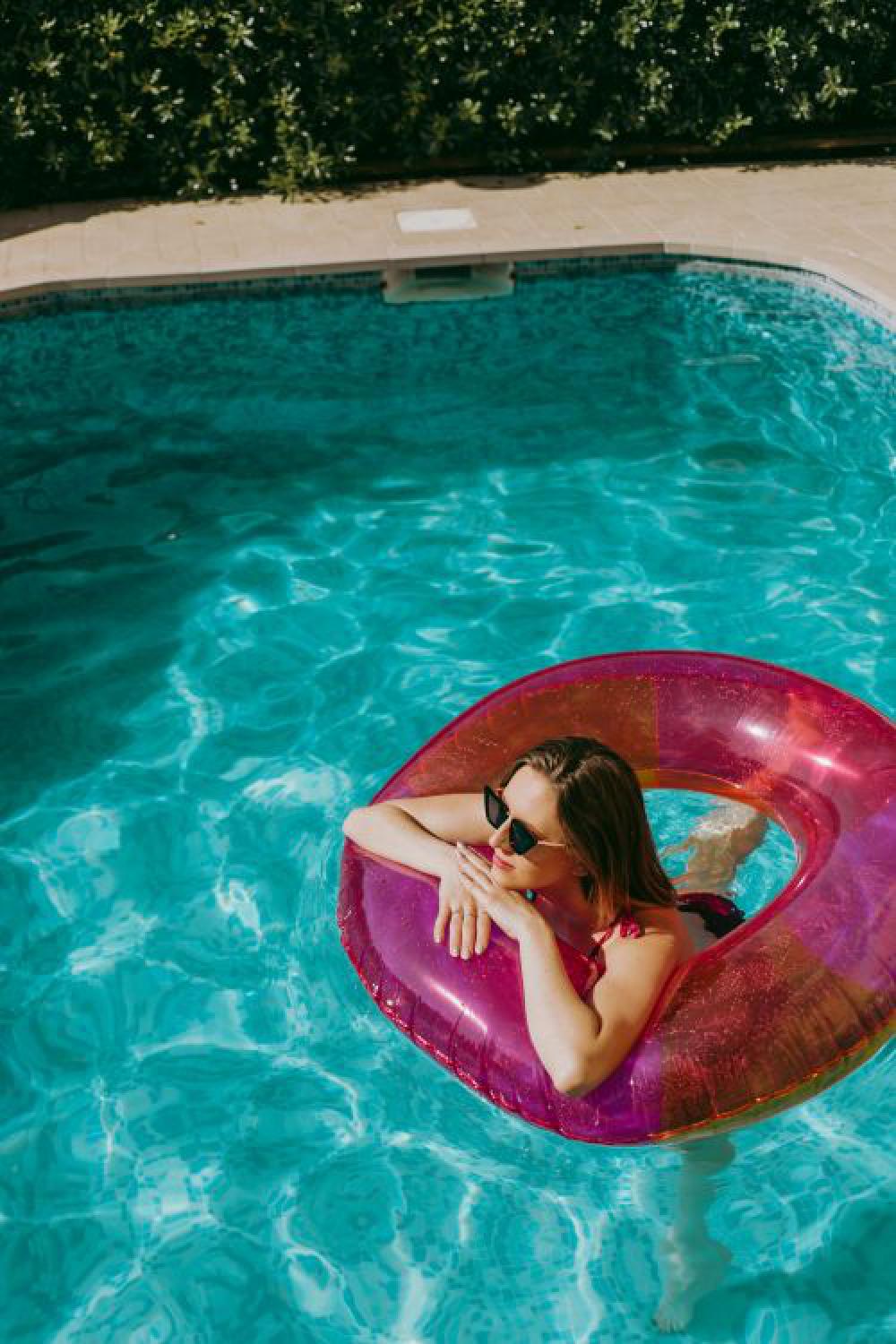 A beautiful woman in a pool with an inflatable ring A beautiful woman in a pool with an inflatable ring