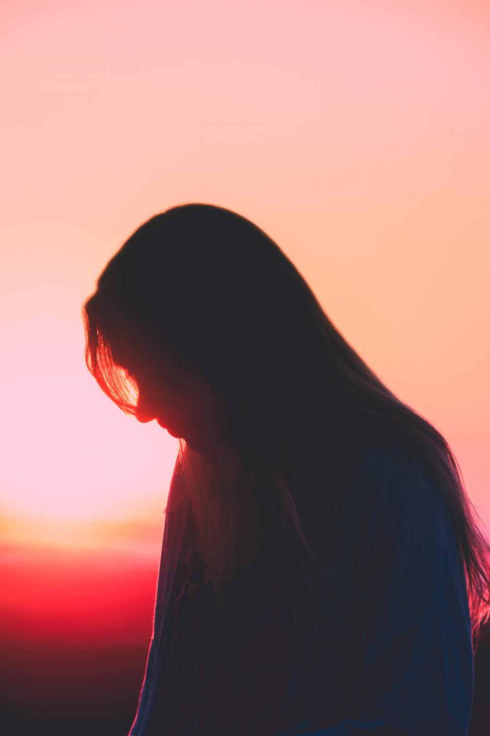 Silhouette of woman during sunset at beach. Silhouette of woman during sunset at beach.