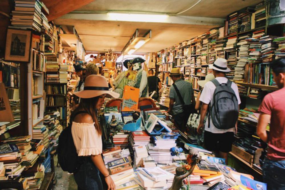 Girl buying books in a bookstore. Girl buying books in a bookstore.