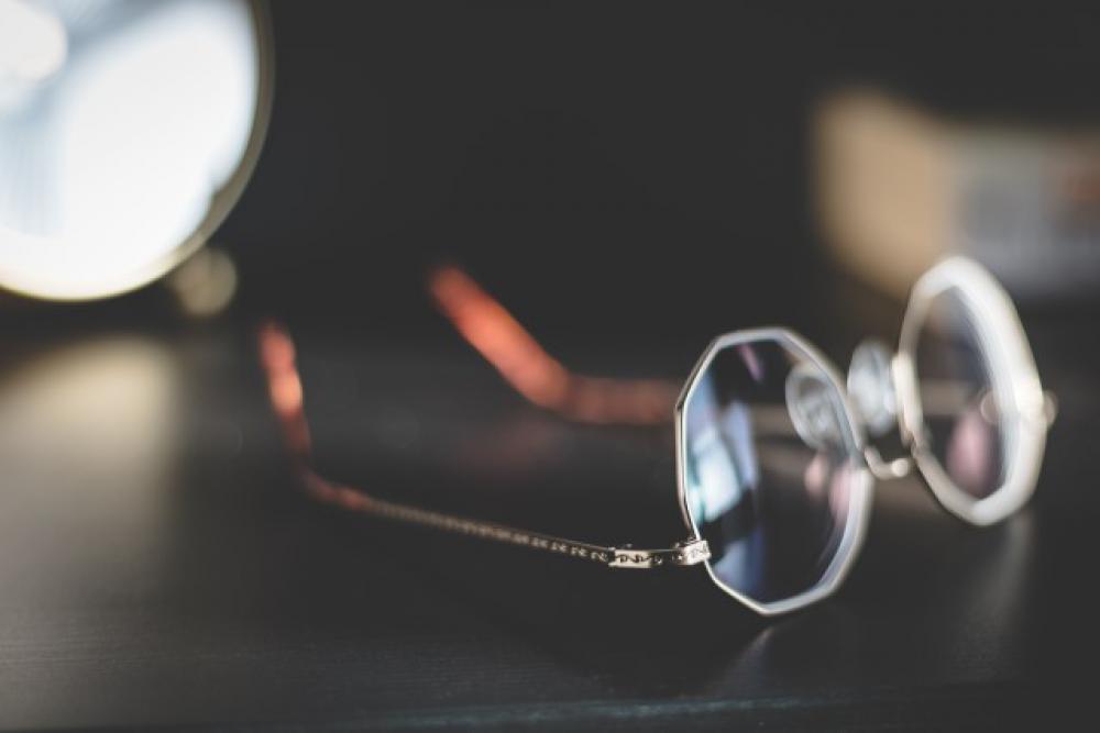 Glasses on a bedside table. Glasses on a bedside table.