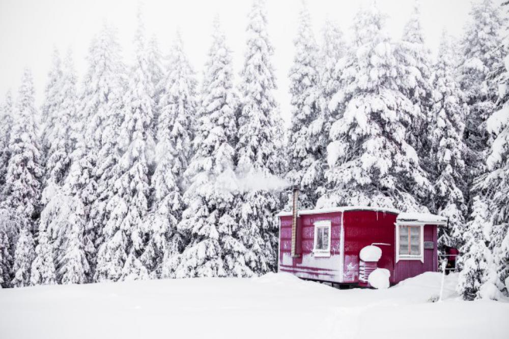 red house covered in snow in deep winter red house covered in snow in deep winter