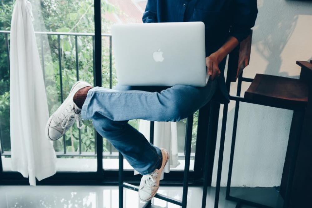 Woman working with laptop on chair. Woman working with laptop on chair.