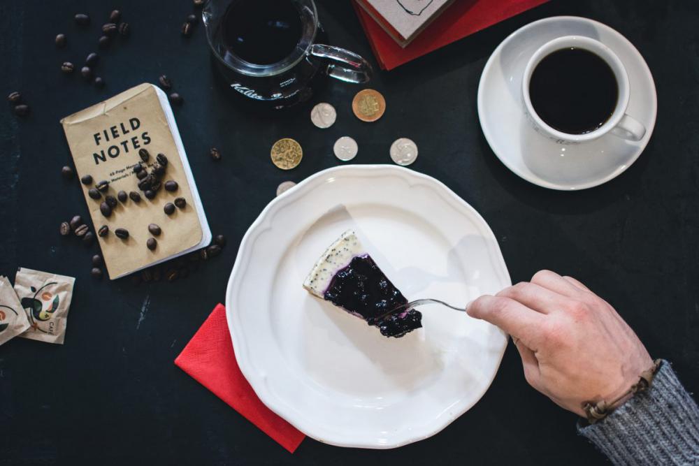 Eating blueberry cheesecake in a coffee shop Eating blueberry cheesecake in a coffee shop