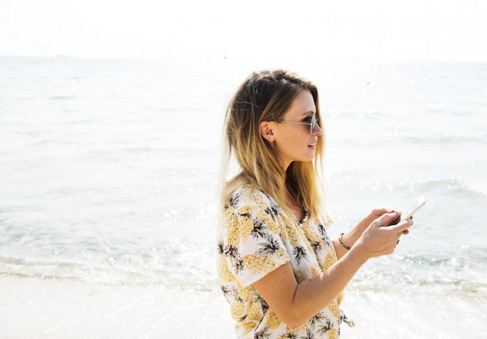 Girl on the Beach using Mobile phone Girl on the Beach using Mobile phone