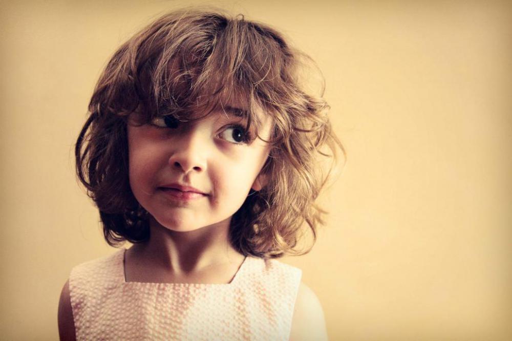 Little girl with mischievous look Little girl with mischievous look
