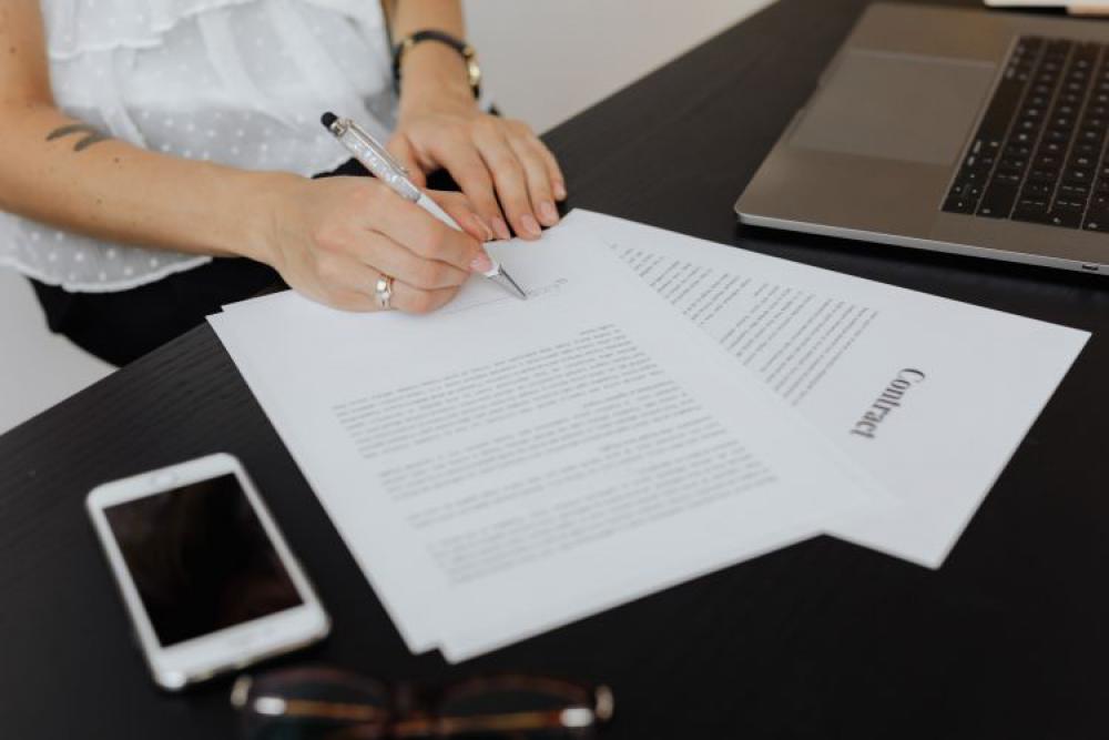 A businesswoman works at a desk with a laptop A businesswoman works at a desk with a laptop