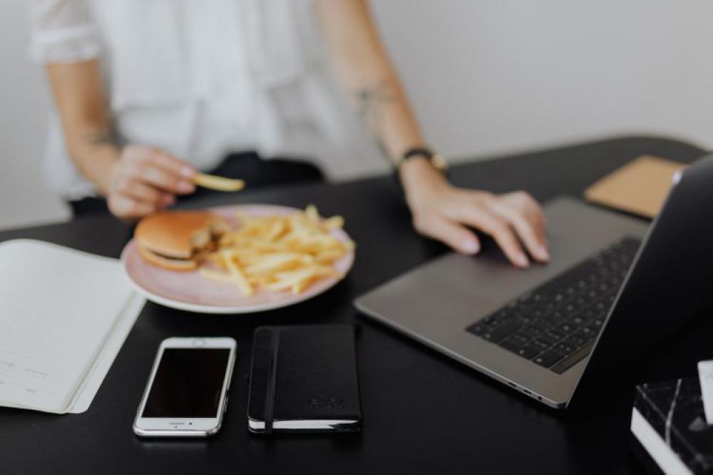 A businesswoman works at a desk with a laptop A businesswoman works at a desk with a laptop