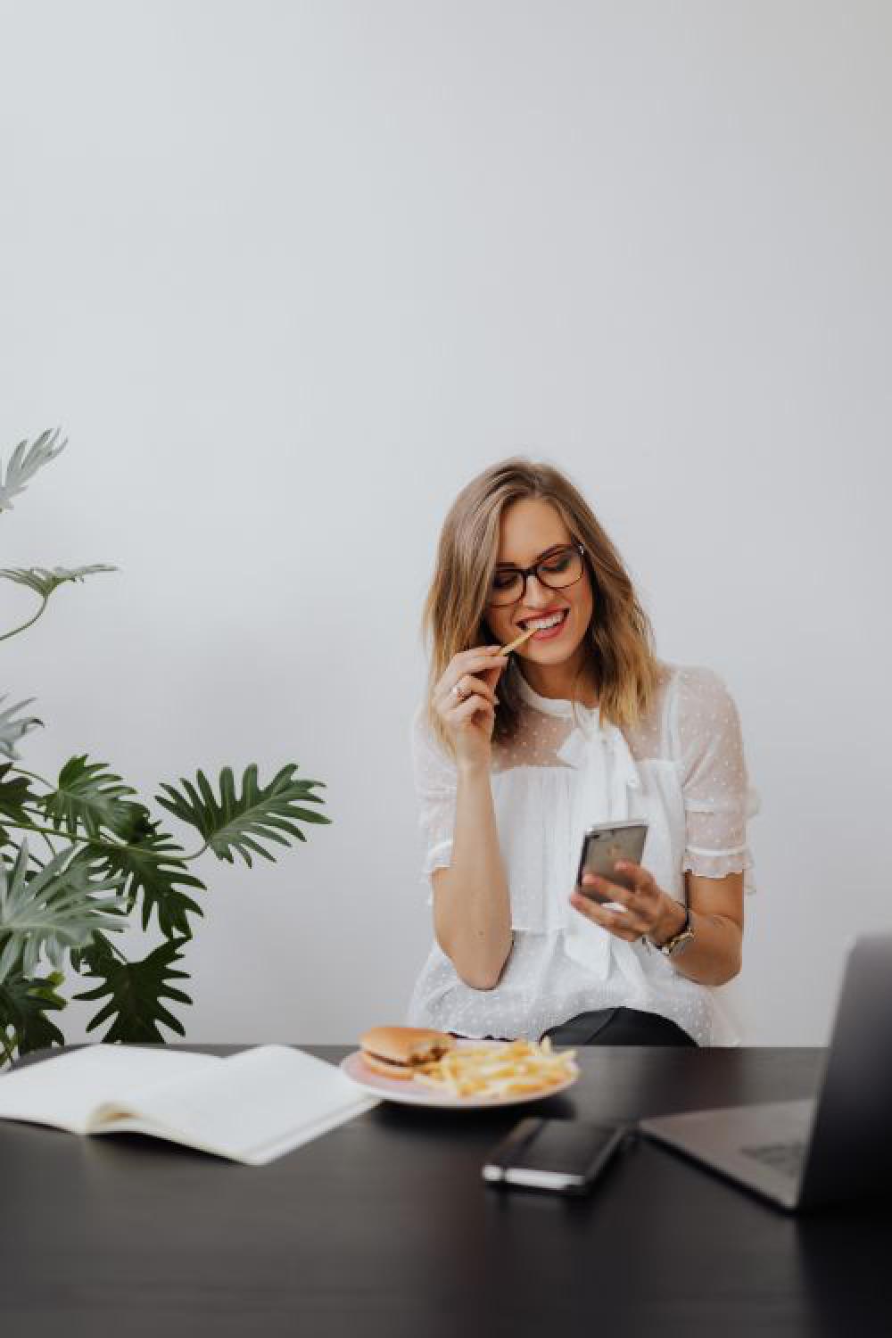 A businesswoman works at a desk with a laptop A businesswoman works at a desk with a laptop