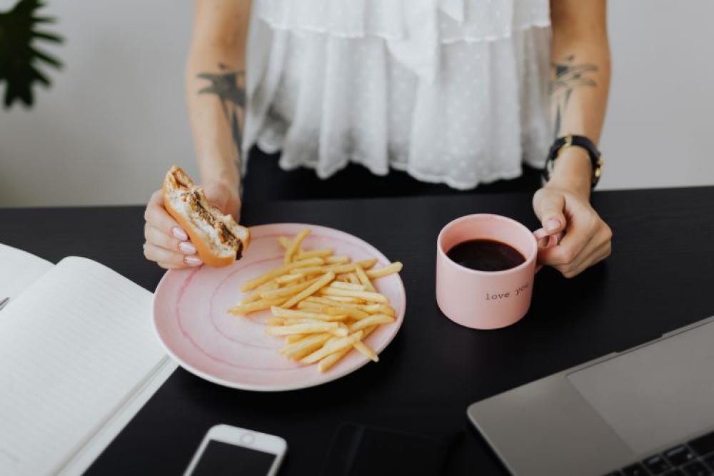 A businesswoman works at a desk with a laptop A businesswoman works at a desk with a laptop