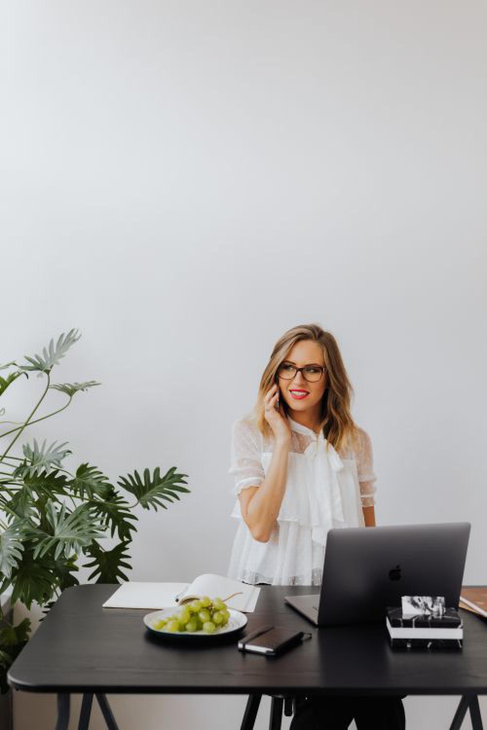 A businesswoman works at a desk with a laptop A businesswoman works at a desk with a laptop