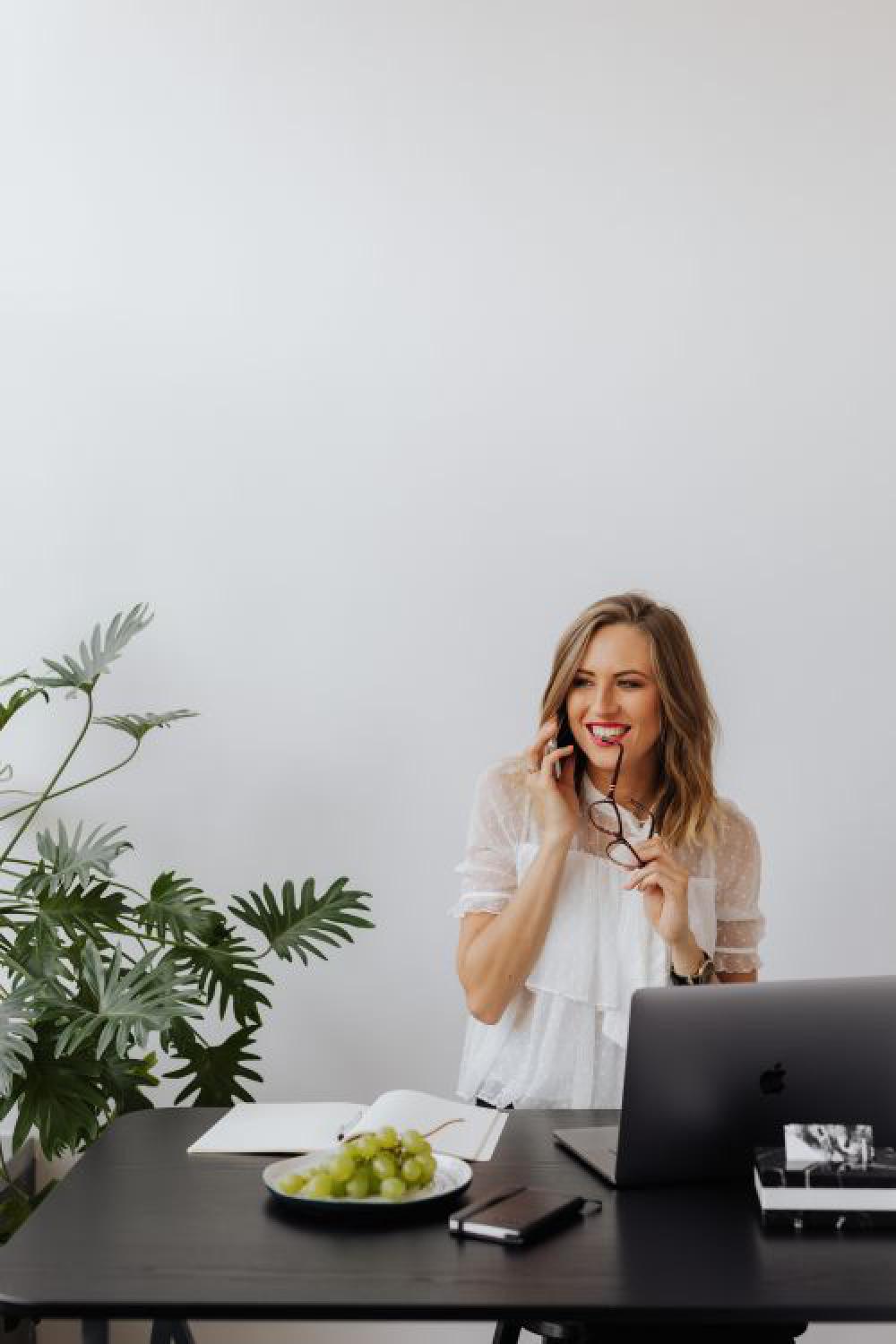 A businesswoman works at a desk with a laptop A businesswoman works at a desk with a laptop
