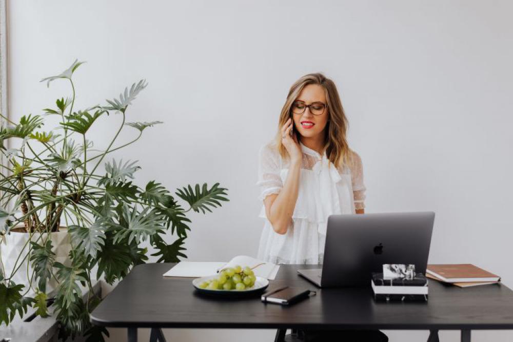 A businesswoman works at a desk with a laptop A businesswoman works at a desk with a laptop