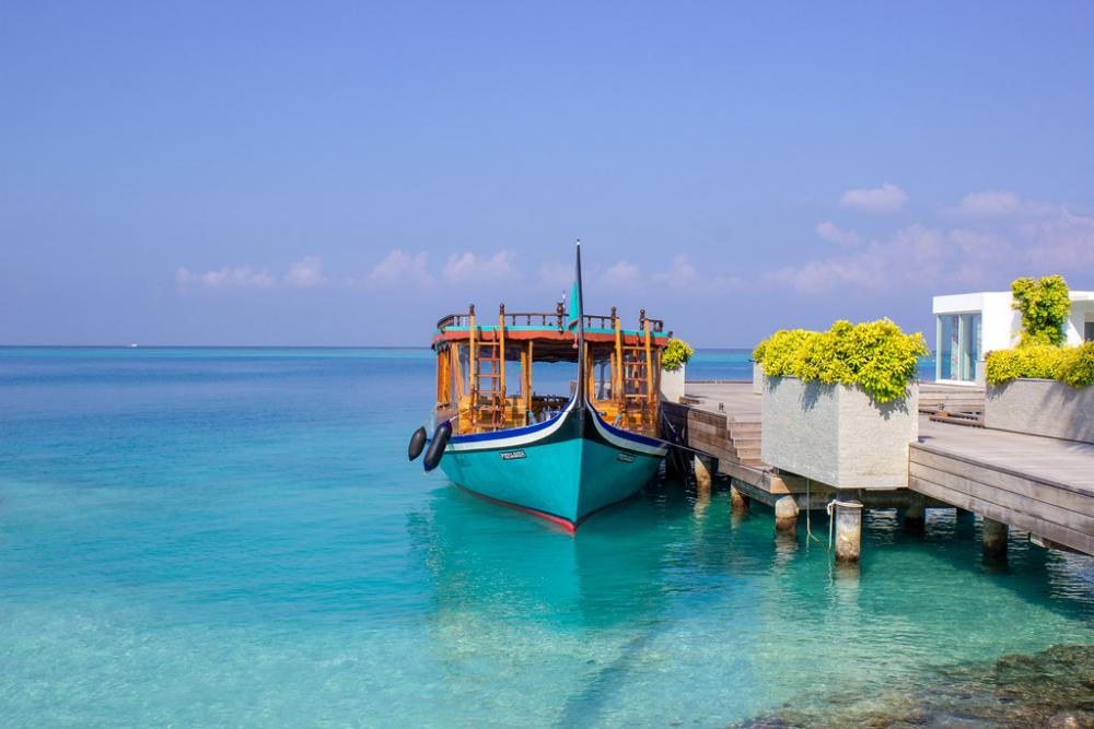 Blue Boat Docked on an Island in Maldives Blue Boat Docked on an Island in Maldives