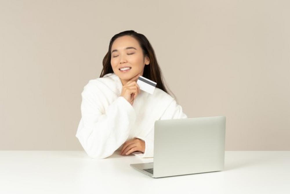 Smiling Young Asian Woman Doing Online Shopping Smiling Young Asian Woman Doing Online Shopping