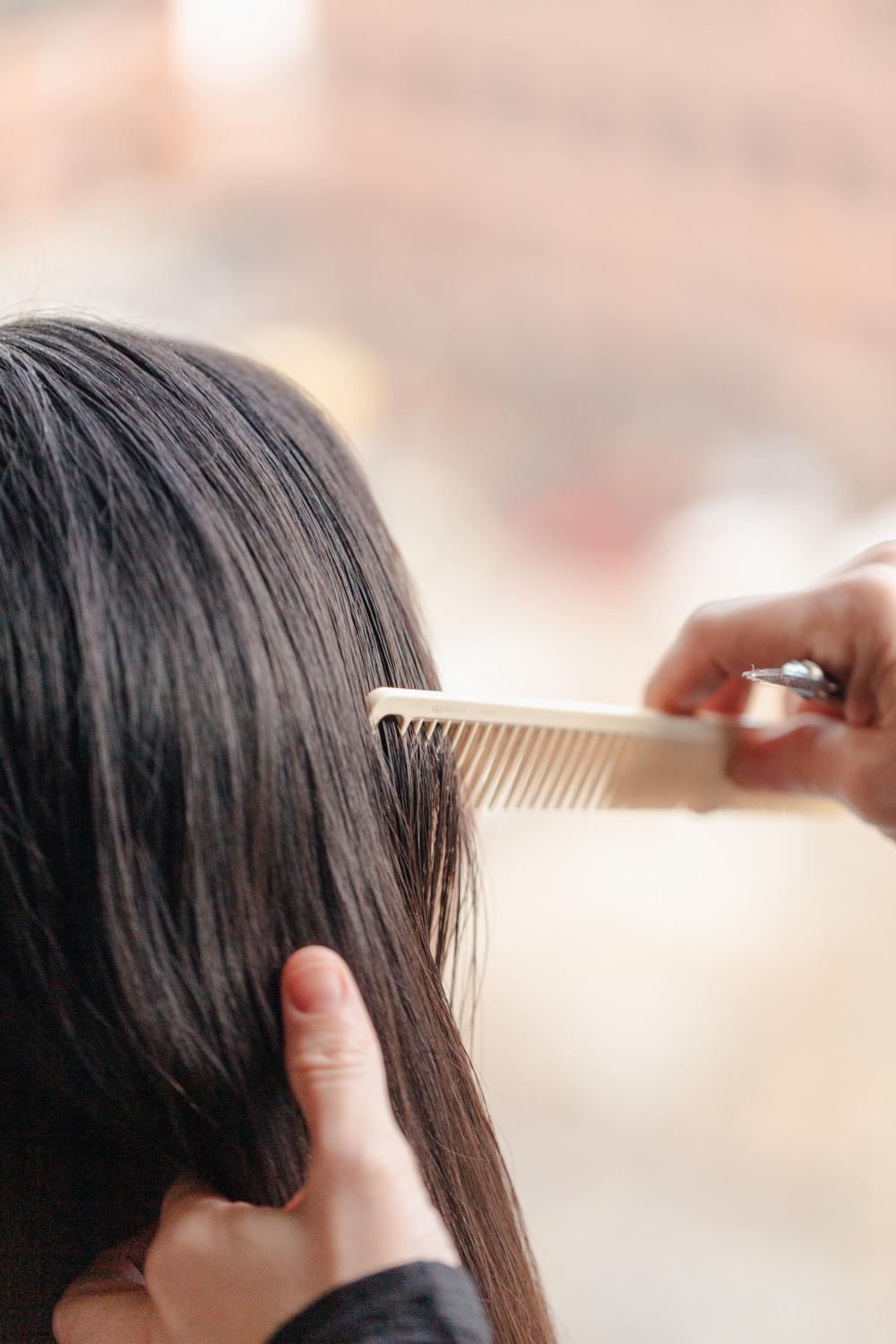 Stylist Combing Through Hair Photo Stylist Combing Through Hair Photo