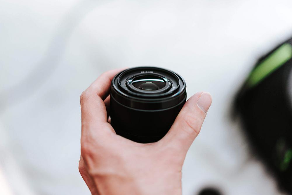 Sony 28mm f2 Lens in Hand Free Photo Sony 28mm f2 Lens in Hand Free Photo