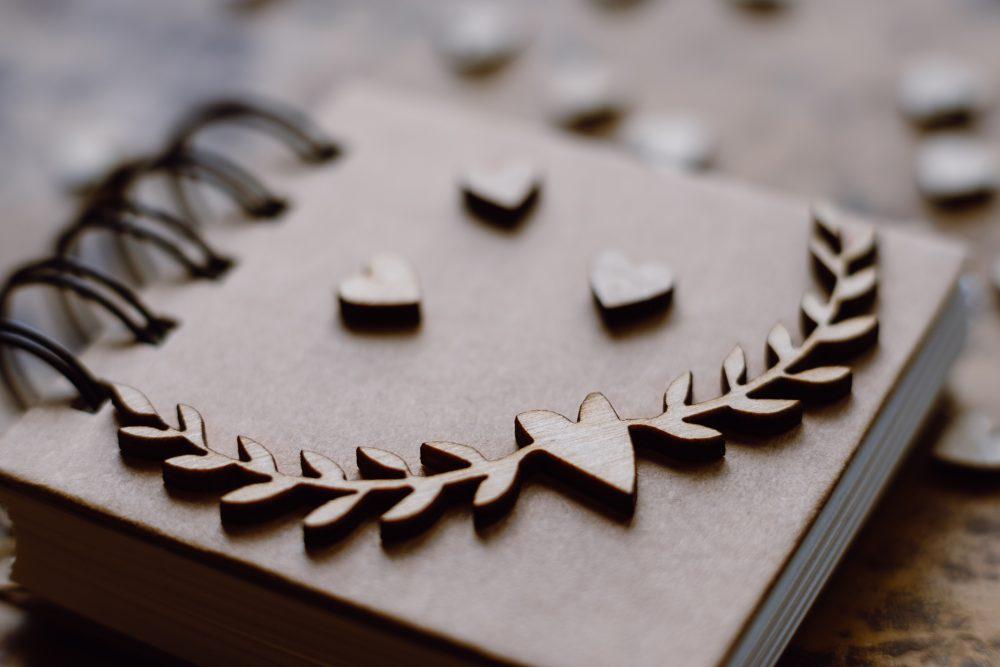 Wooden heart decorations on a notebook Wooden heart decorations on a notebook