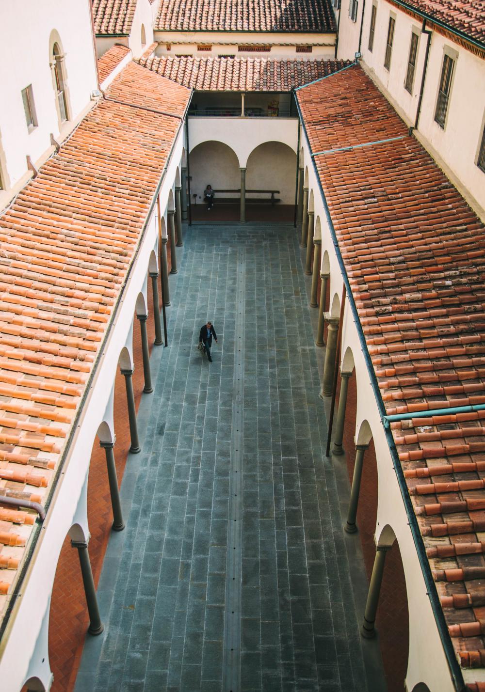 Man Walks Through Narrow Courtyard Photo Man Walks Through Narrow Courtyard Photo