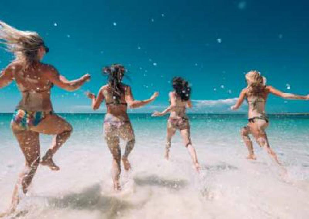 Girls In Bikinis Running Into The Ocean Playfully Girls In Bikinis Running Into The Ocean Playfully
