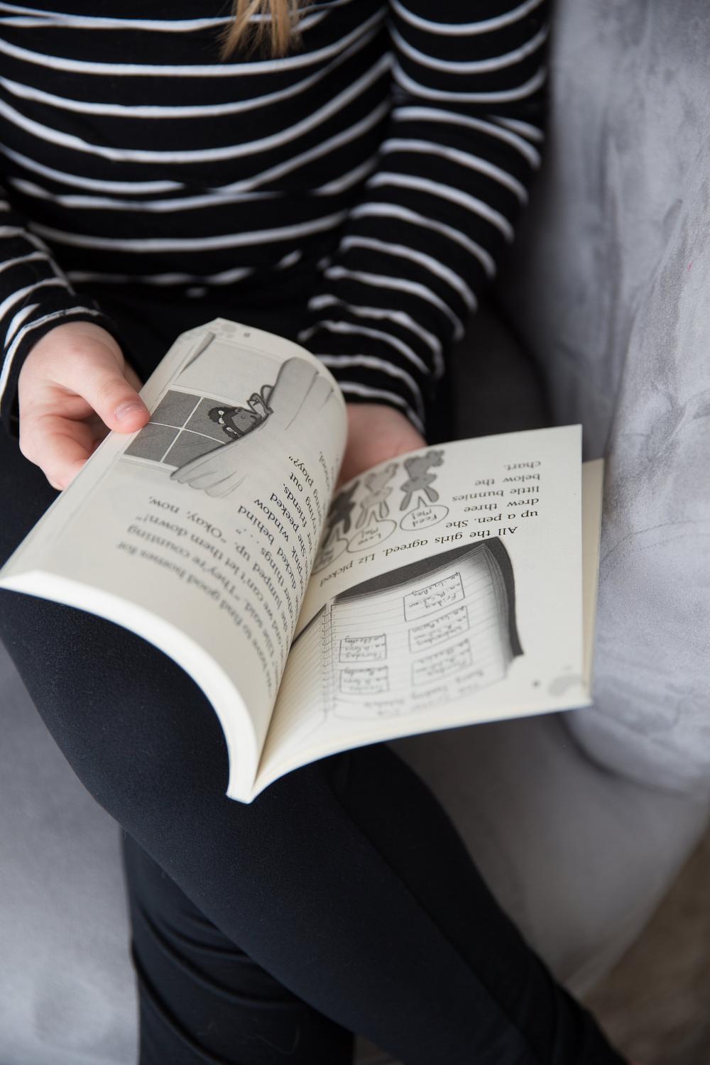 A Young Girl Flips The Page Photo A Young Girl Flips The Page Photo