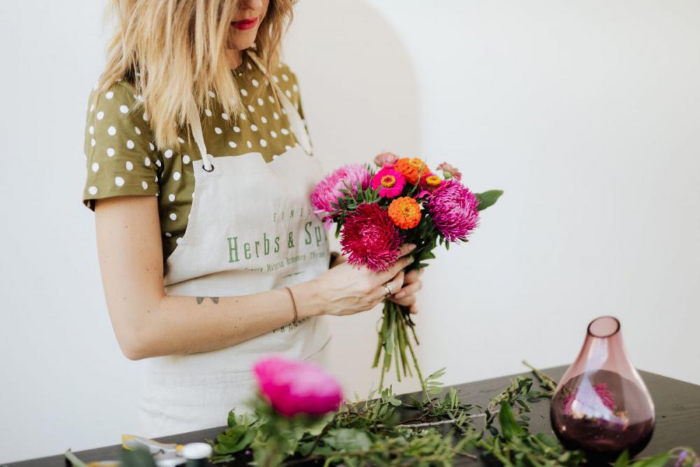 A beautiful woman florist makes a bouquet A beautiful woman florist makes a bouquet