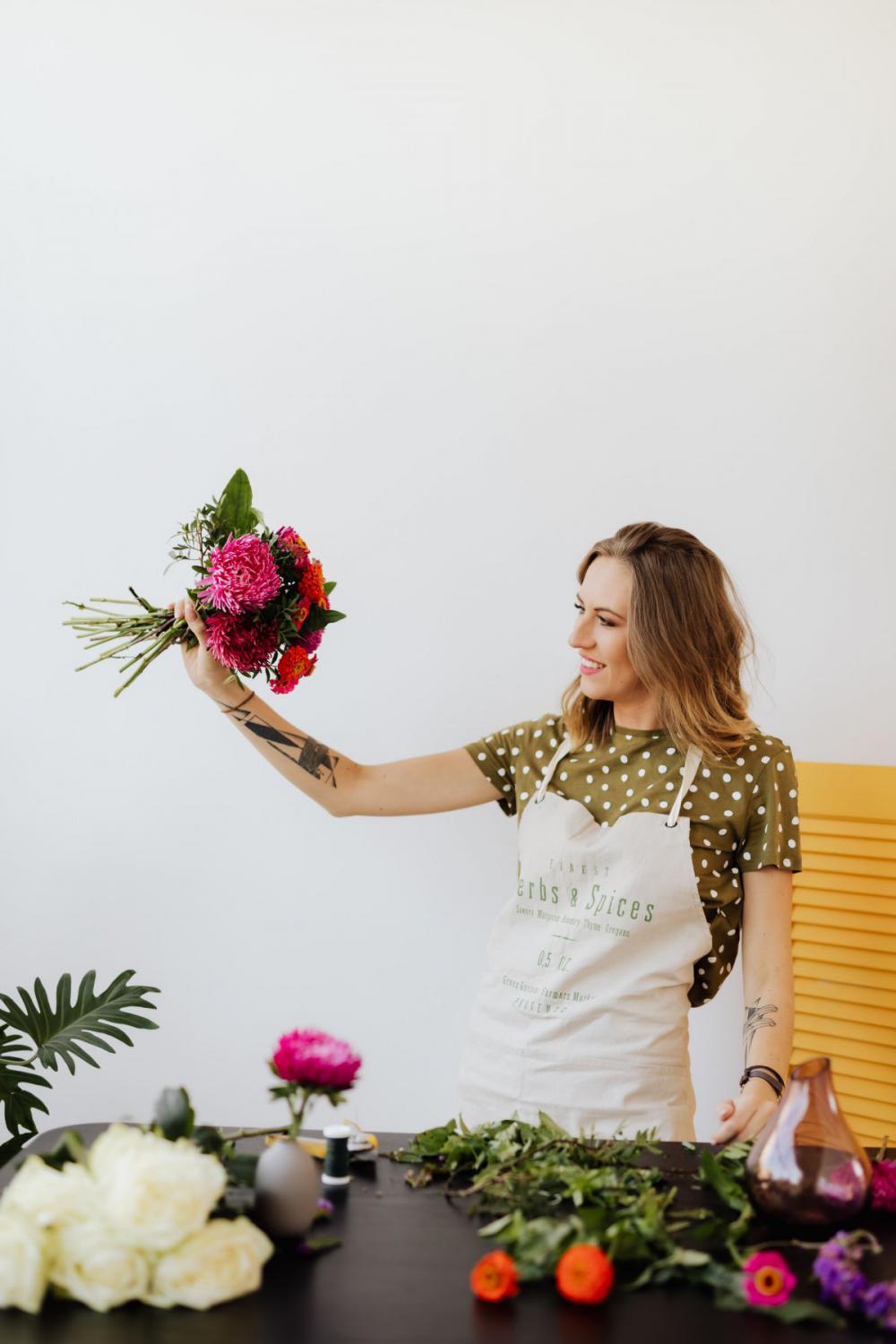 A beautiful woman florist makes a bouquet A beautiful woman florist makes a bouquet