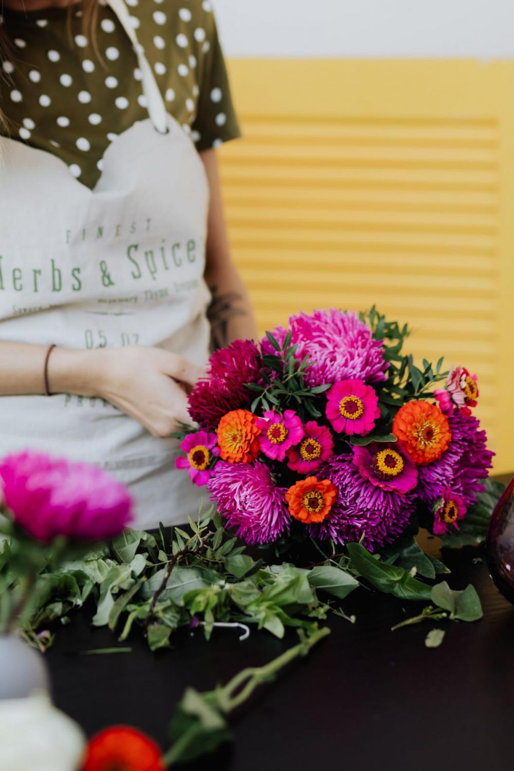 A beautiful woman florist makes a bouquet A beautiful woman florist makes a bouquet