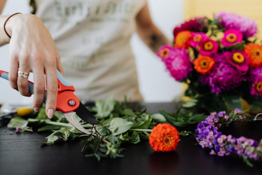 A beautiful woman florist makes a bouquet A beautiful woman florist makes a bouquet