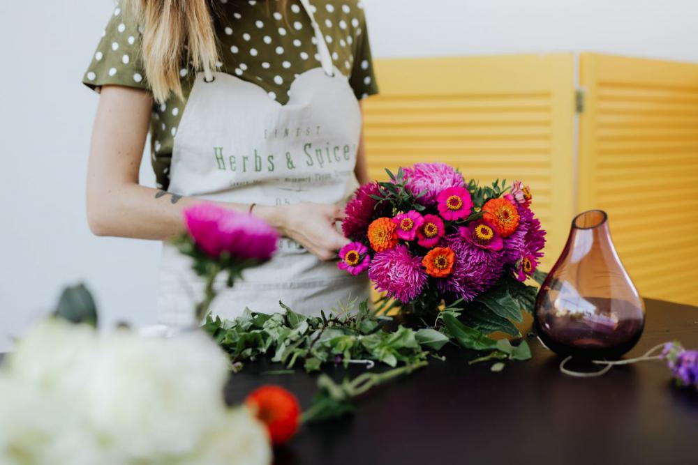 A beautiful woman florist makes a bouquet A beautiful woman florist makes a bouquet