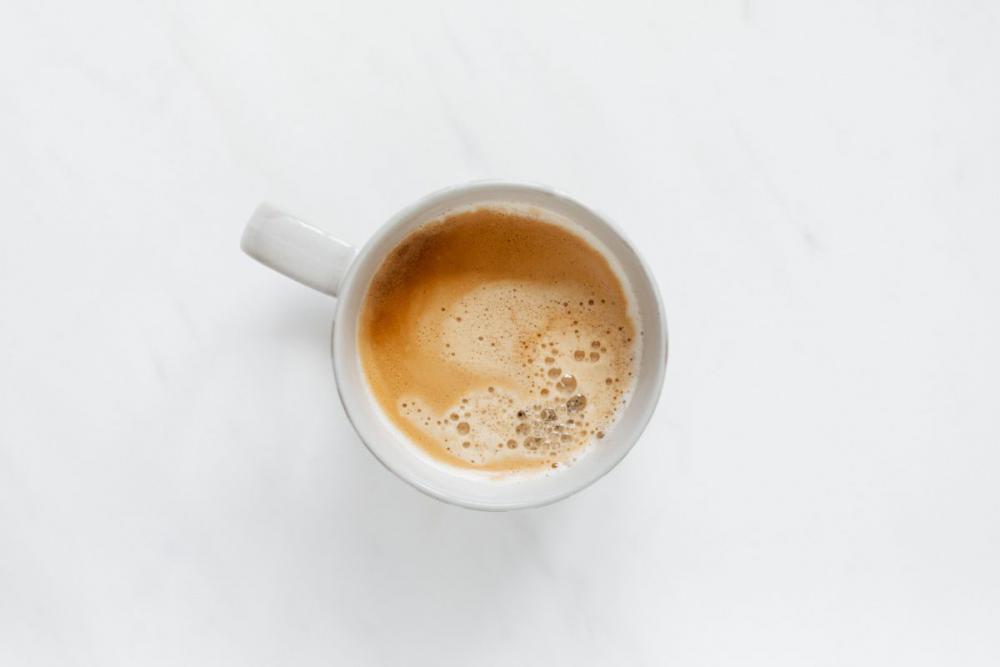 A cup of coffee on white marble A cup of coffee on white marble