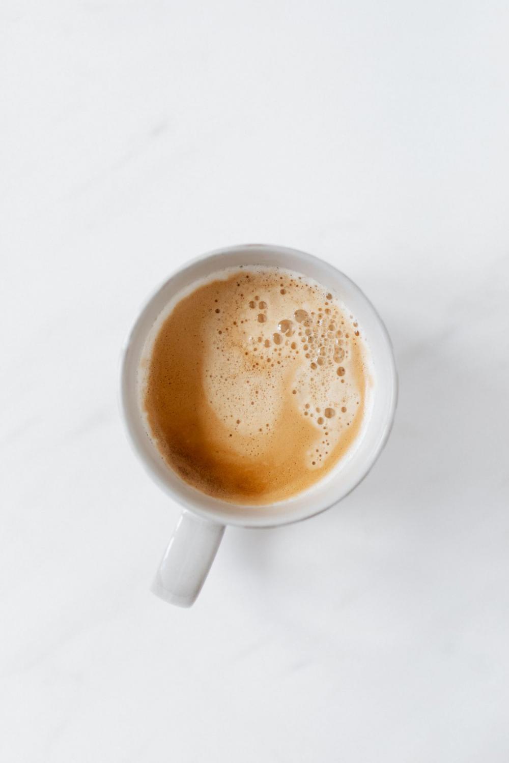 A cup of coffee on white marble A cup of coffee on white marble