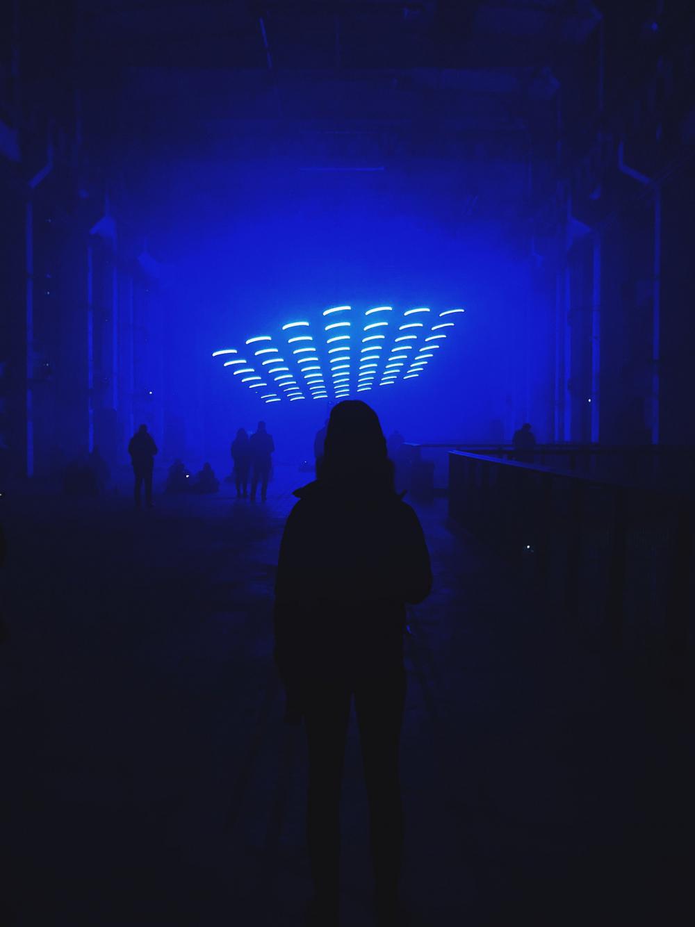 Person Standing In Dim Blue Room Photo Person Standing In Dim Blue Room Photo