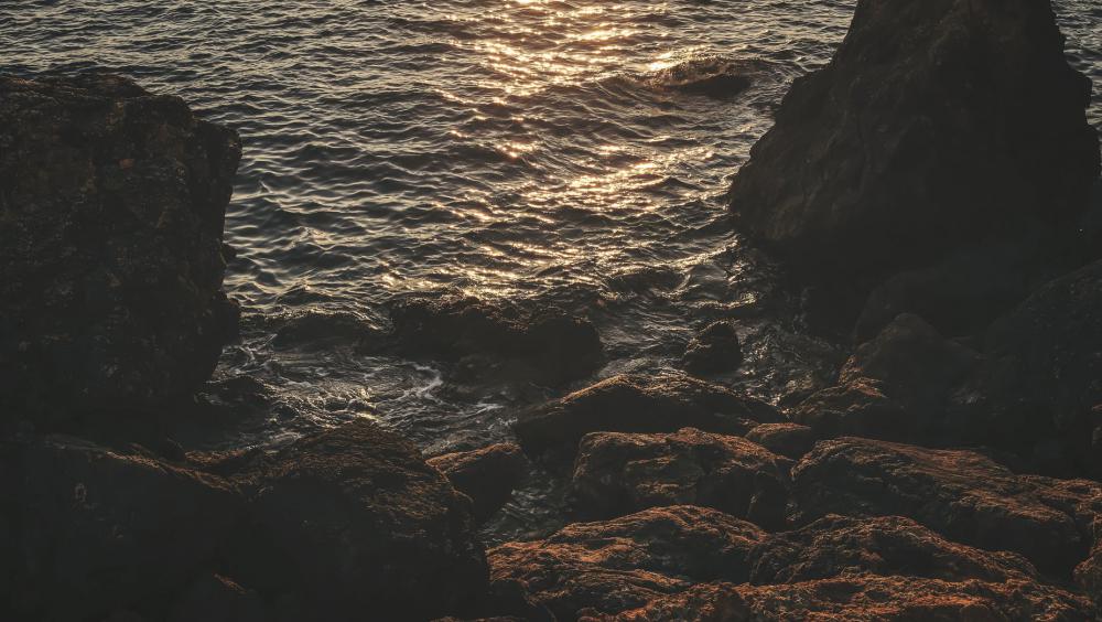 Rocky Shoreline Lit By Orange Sunset Photo Rocky Shoreline Lit By Orange Sunset Photo