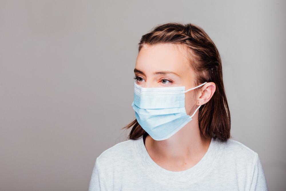Portrait Of A Woman Wearing Disposable Face Mask Photo Portrait Of A Woman Wearing Disposable Face Mask Photo