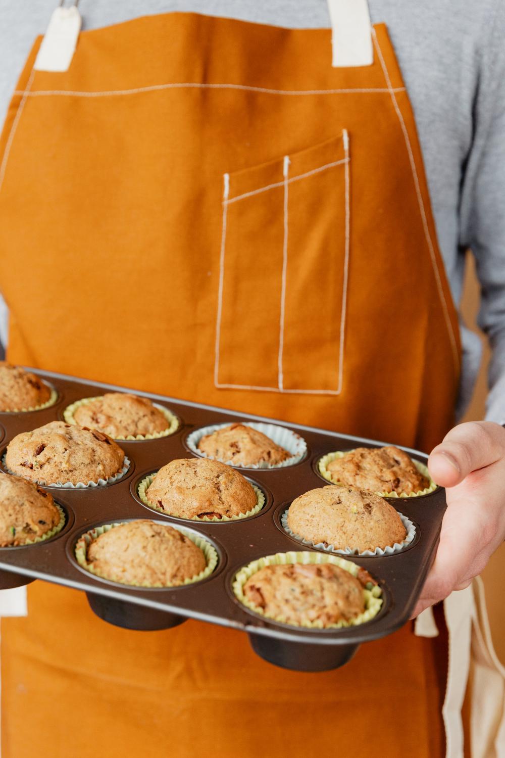 Baker Holding Fresh Muffins Photo Baker Holding Fresh Muffins Photo