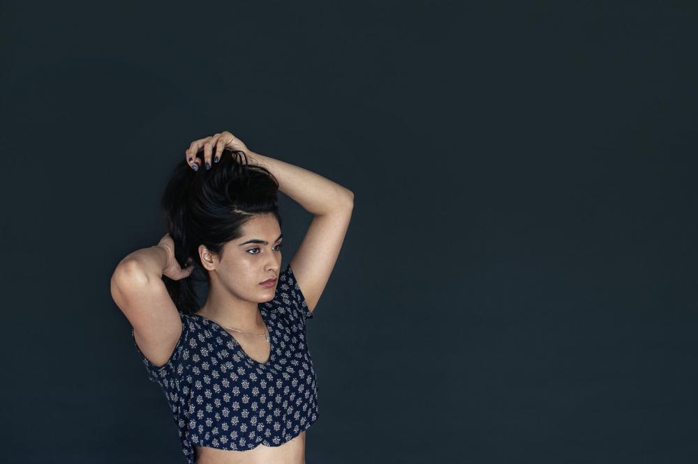 Woman With Hair Bunched Up In Hands Photo Woman With Hair Bunched Up In Hands Photo