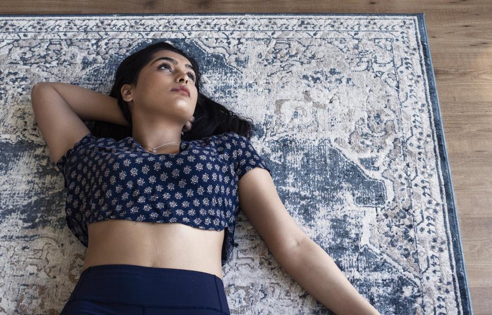 Woman In Blue Yoga Attire On Blue Rug Photo Woman In Blue Yoga Attire On Blue Rug Photo