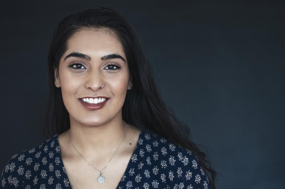 Young Woman In Blue Smiling Photo Young Woman In Blue Smiling Photo