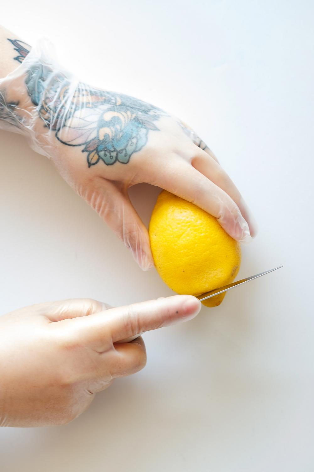 Tattooed Hands Cut A Lemon Photo Tattooed Hands Cut A Lemon Photo