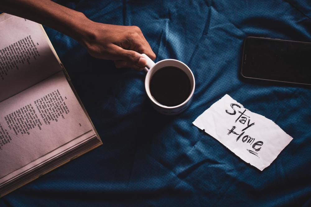 Hand Holding Coffee Near Book And Phone. Photo Hand Holding Coffee Near Book And Phone. Photo