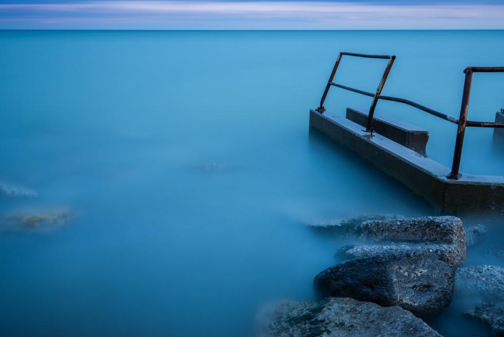 Mist Rolling Over Water By Some Rocks Photo Mist Rolling Over Water By Some Rocks Photo