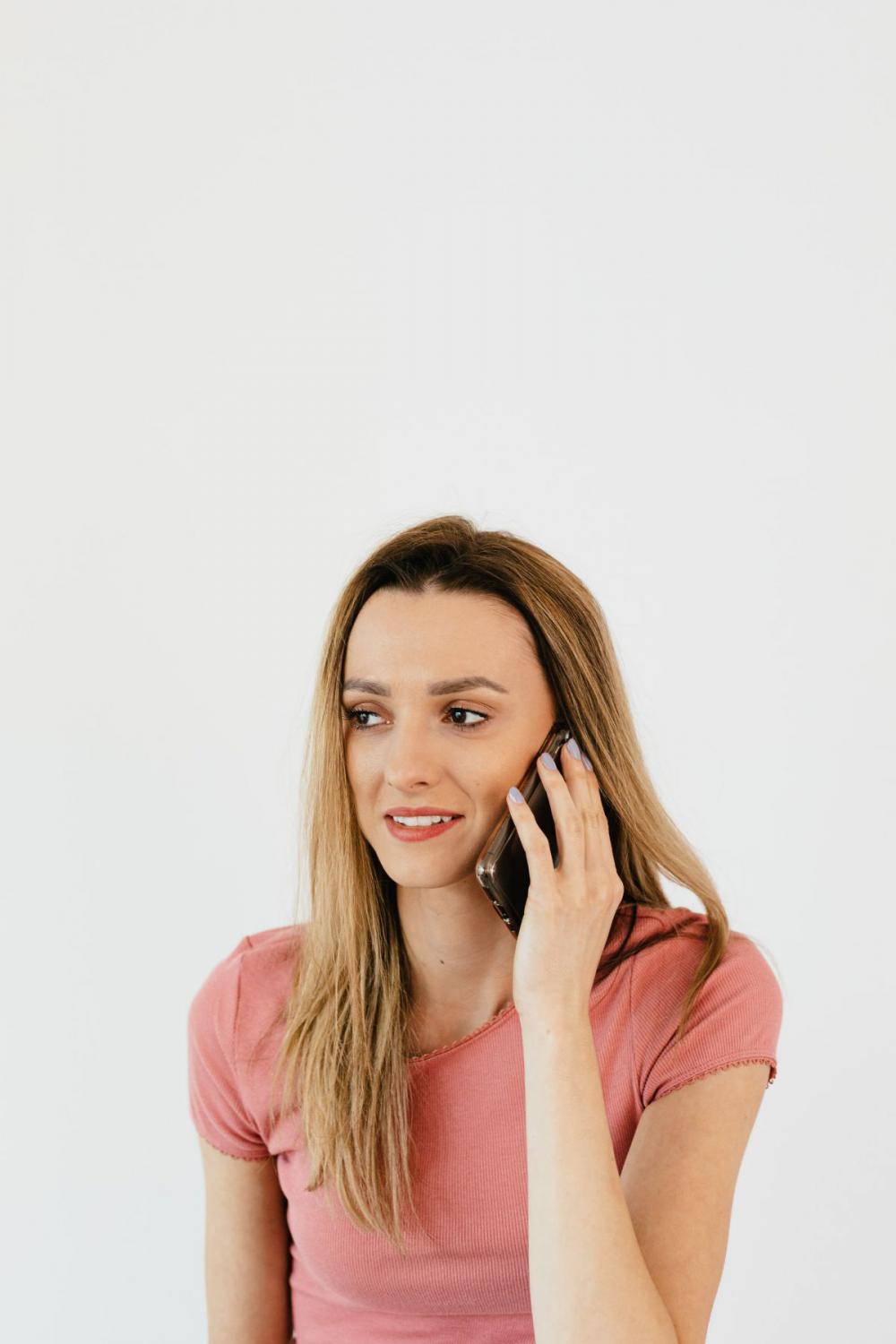 Young woman with laptop & mobile phone at home Young woman with laptop & mobile phone at home