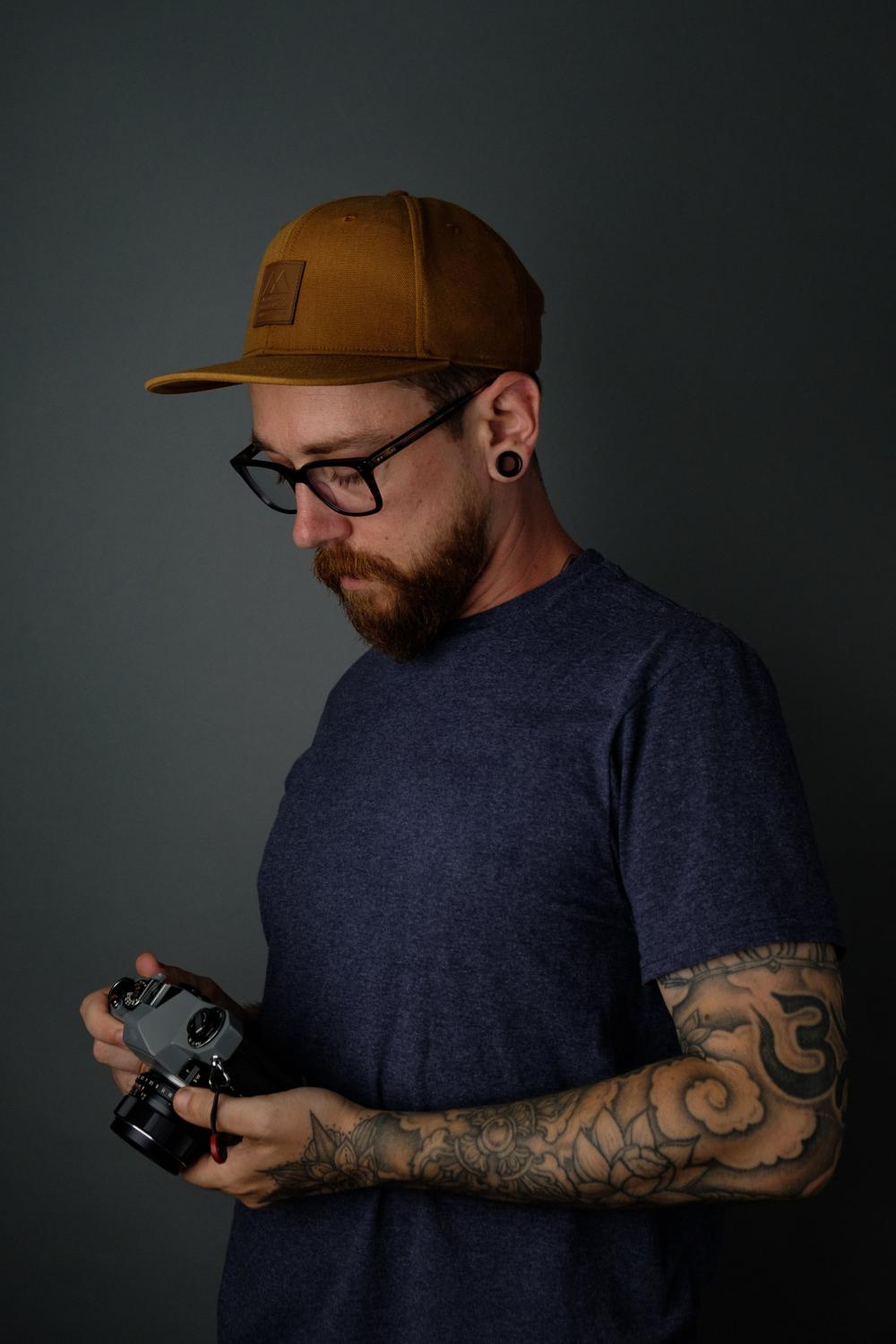 Tattooed Man Holding Film Camera Photo Tattooed Man Holding Film Camera Photo