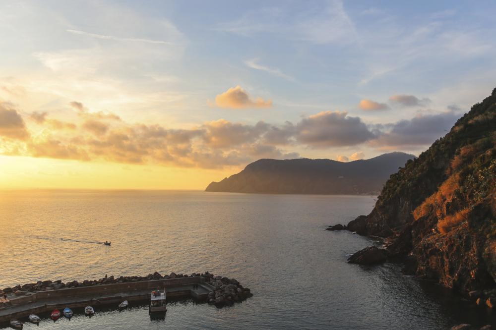 Sunset On The Water And A Cliff In Italy Photo Sunset On The Water And A Cliff In Italy Photo