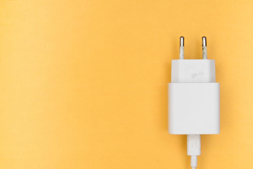 White Phone Charger On Yellow Photo White Phone Charger On Yellow Photo