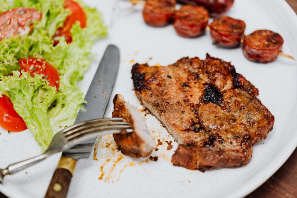 The pork neck is roasted on the grill The pork neck is roasted on the grill